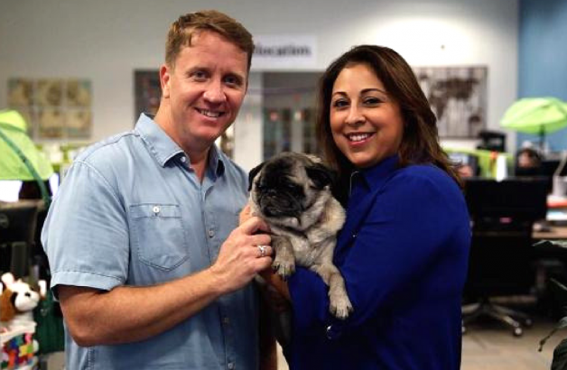 PetRelocation owners, Kevin and Angie holding a dog.