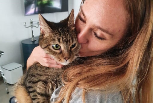 A woman kissing her cat