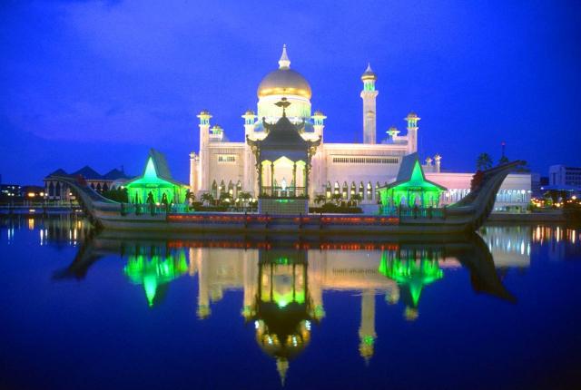 omar ali saifuddien mosque with stone boat and lagoon at night