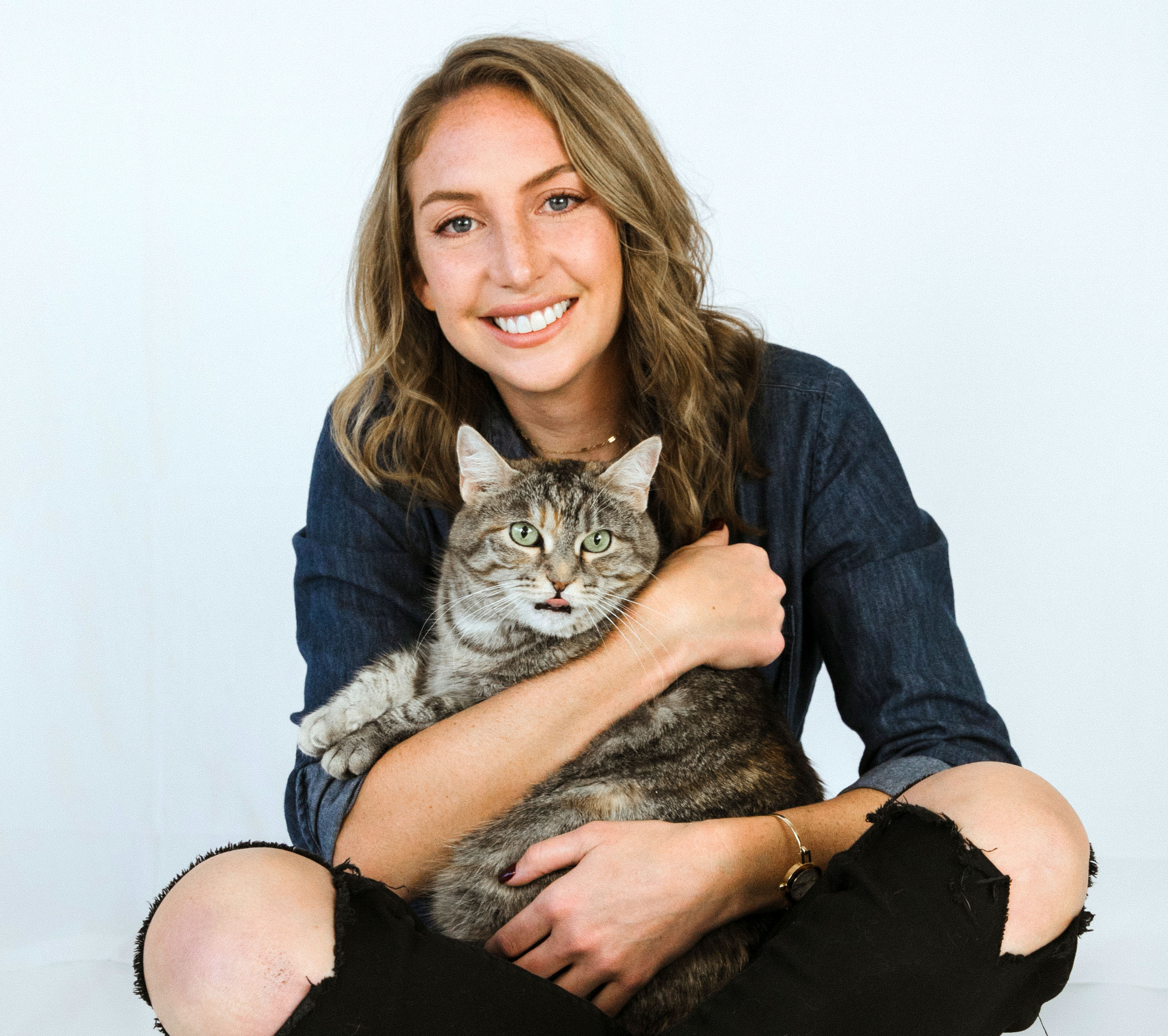 Katie Harris relocation coordinator holding her cat 